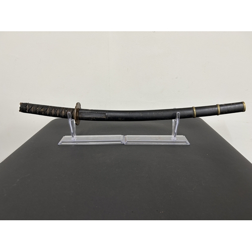214 - An antique Wakizashi Japanese sword in a wooden scabbard, polished blade with an unusual mark, light... 