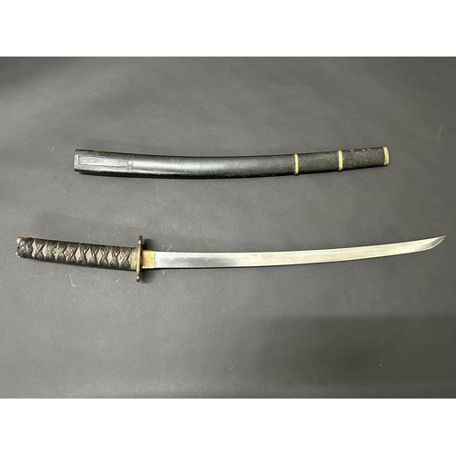 214 - An antique Wakizashi Japanese sword in a wooden scabbard, polished blade with an unusual mark, light... 