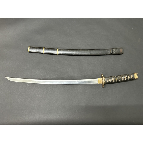 214 - An antique Wakizashi Japanese sword in a wooden scabbard, polished blade with an unusual mark, light... 
