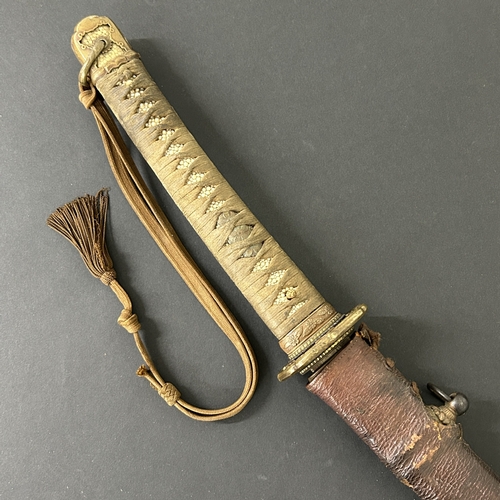 215 - A Shin-Gunto Japanese sword in a leather covered metal military scabbard, old blade with hamon marks... 