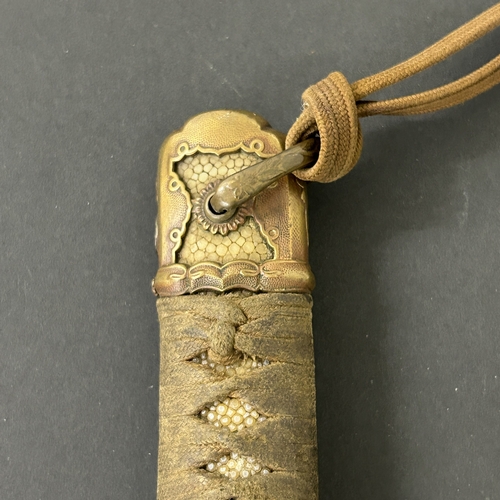 215 - A Shin-Gunto Japanese sword in a leather covered metal military scabbard, old blade with hamon marks... 