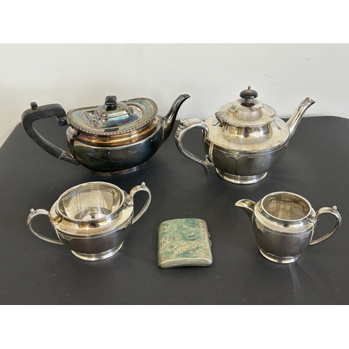 121 - A vintage three piece silver plated tea set together with a further teapot and a cigarette case