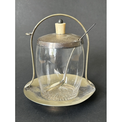 125 - A silver plated base preserve stand with a hallmarked silver lid and spoon, with 'broad arrow' mark ... 