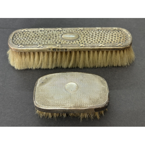 127 - Two hallmarked silver dressing table brushes