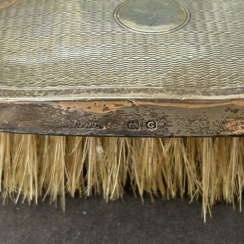 127 - Two hallmarked silver dressing table brushes