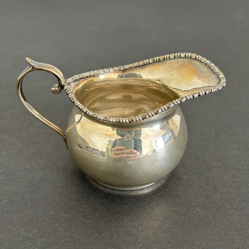 133 - A hallmarked silver small jug, weight approx. 42g (dent to one side)
