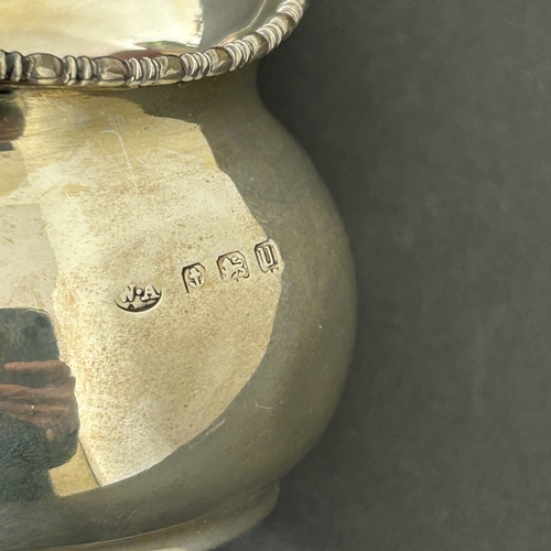 133 - A hallmarked silver small jug, weight approx. 42g (dent to one side)