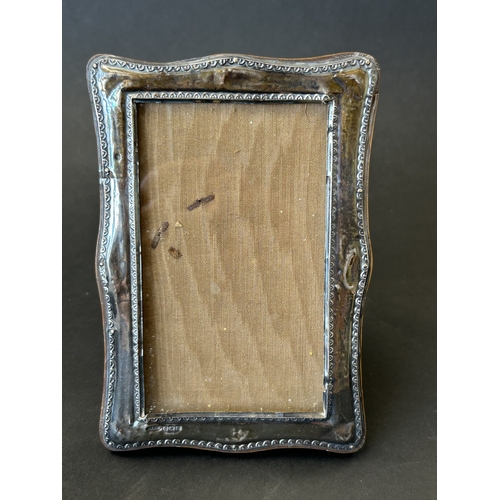 139 - A wooden frame photo holder with hallmarked silver front, approx. 6