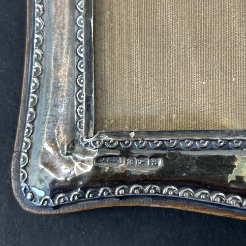 139 - A wooden frame photo holder with hallmarked silver front, approx. 6