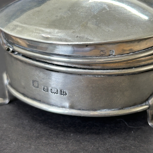 144 - A hallmarked silver and velvet lined trinket pot on three claw feet, weight approx. 35g