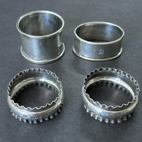 145 - A pair of hallmarked silver napkin rings together with two others, total weight approx. 46g