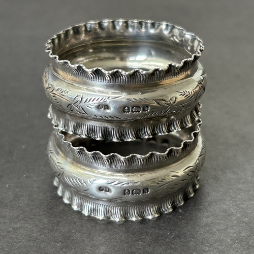 145 - A pair of hallmarked silver napkin rings together with two others, total weight approx. 46g