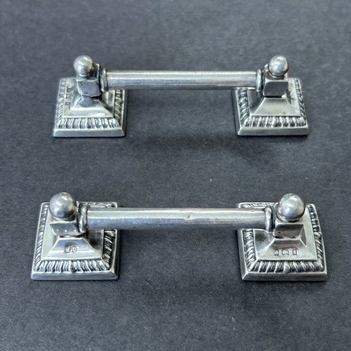 147 - A pair of hallmarked silver knife rests with filled bases, approx. 3 1/2