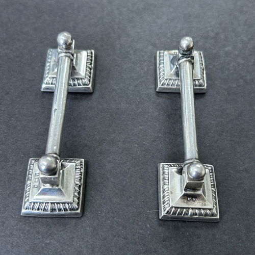 147 - A pair of hallmarked silver knife rests with filled bases, approx. 3 1/2