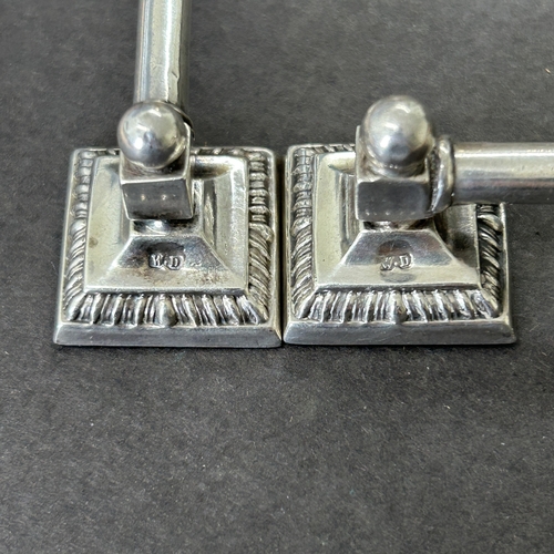 147 - A pair of hallmarked silver knife rests with filled bases, approx. 3 1/2