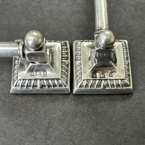 147 - A pair of hallmarked silver knife rests with filled bases, approx. 3 1/2