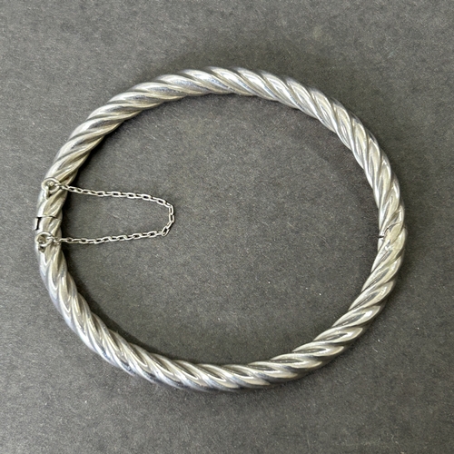 6 - A 925 sterling silver bangle with safety chain, weight approx. 13g