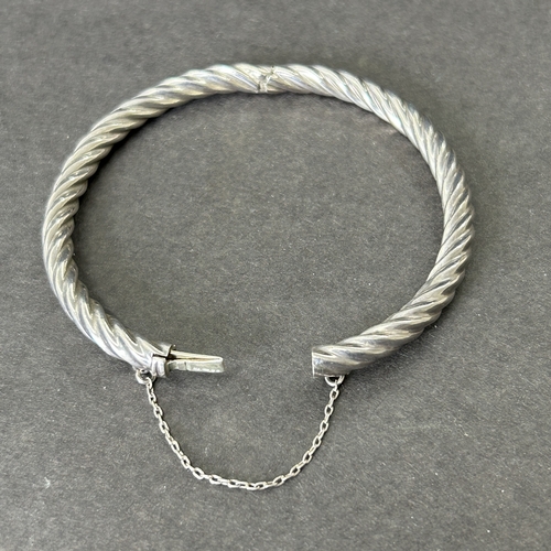 6 - A 925 sterling silver bangle with safety chain, weight approx. 13g