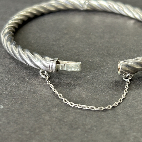 6 - A 925 sterling silver bangle with safety chain, weight approx. 13g