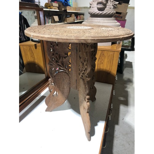 233 - Heavily carved Indian coffee table with foldable legs and removable inlaid top
