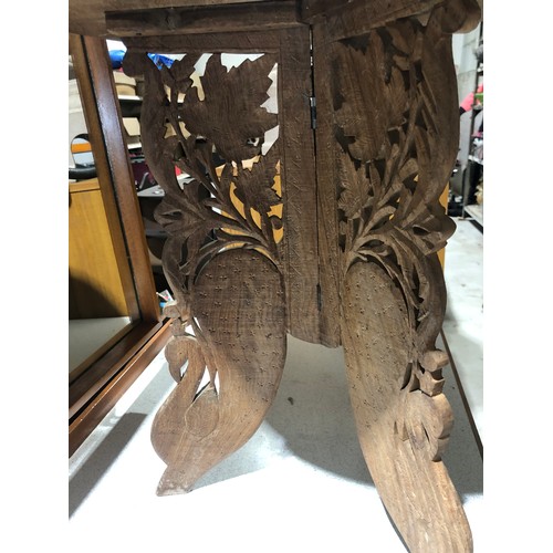 233 - Heavily carved Indian coffee table with foldable legs and removable inlaid top