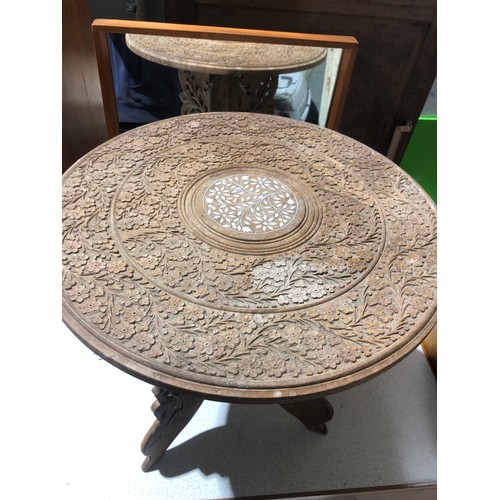 233 - Heavily carved Indian coffee table with foldable legs and removable inlaid top