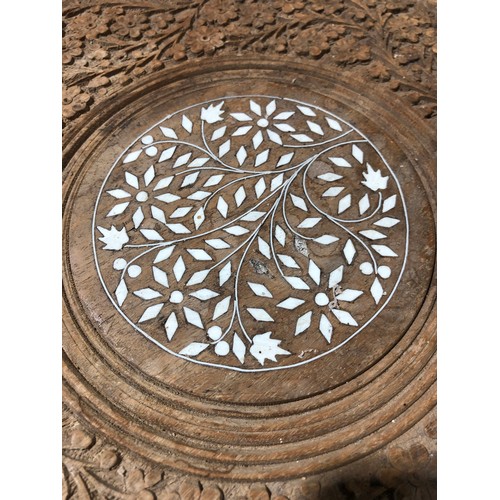 233 - Heavily carved Indian coffee table with foldable legs and removable inlaid top