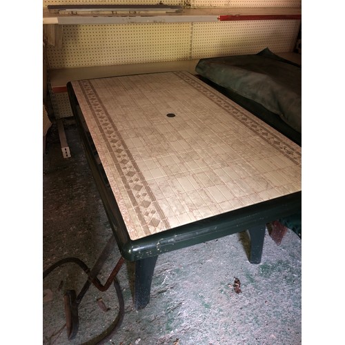 553 - Green plastic garden table with tile style top