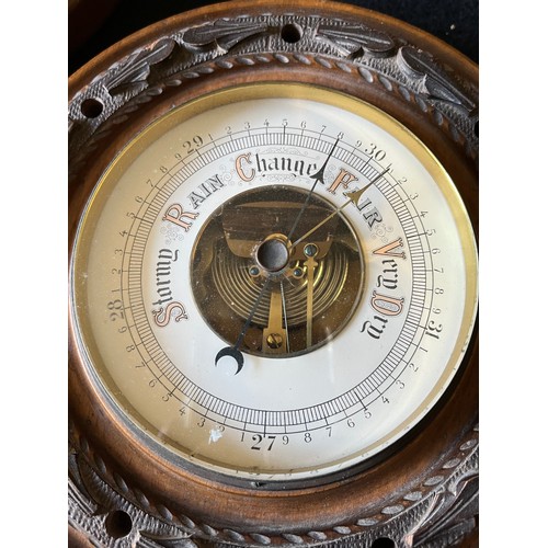 785 - Old wood cased wall hanging Barometer with open window to view workings, set in a carved plaque. num... 