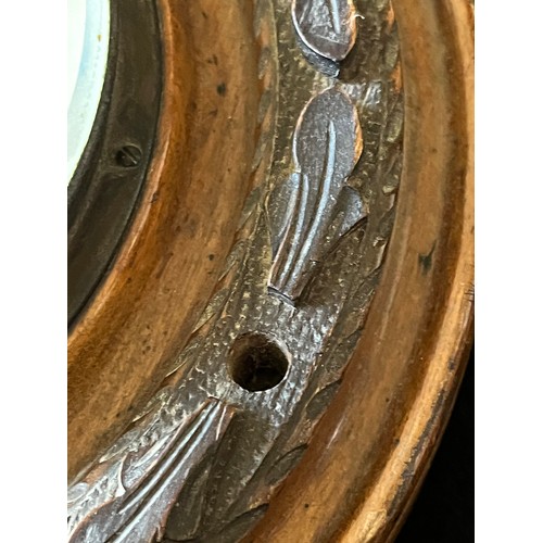 785 - Old wood cased wall hanging Barometer with open window to view workings, set in a carved plaque. num... 