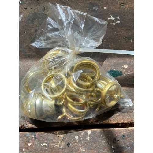 826 - Bag of brass coloured plastic curtain rings