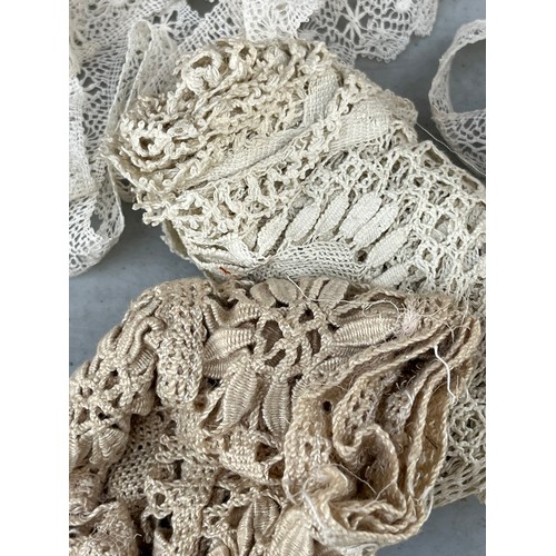 1072 - Antique Victorian Textiles - Rolls of lace edging etc in a satin soft bag