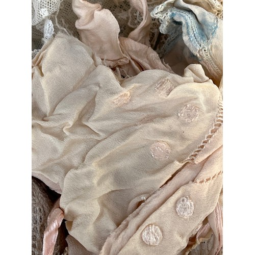 1072 - Antique Victorian Textiles - Rolls of lace edging etc in a satin soft bag