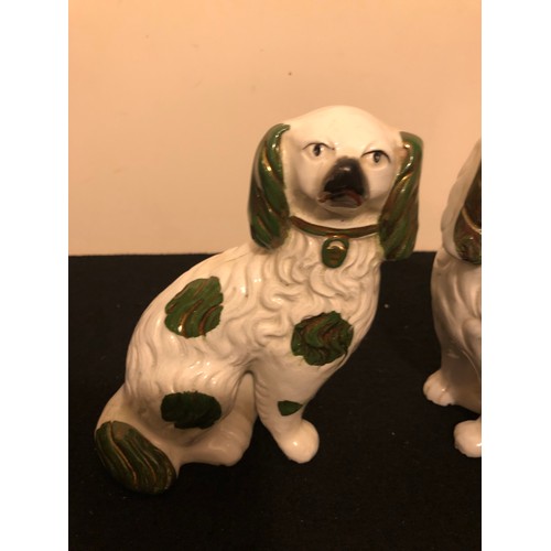 1146 - Pair of Staffordshire Spaniel Dogs with a green lustre.