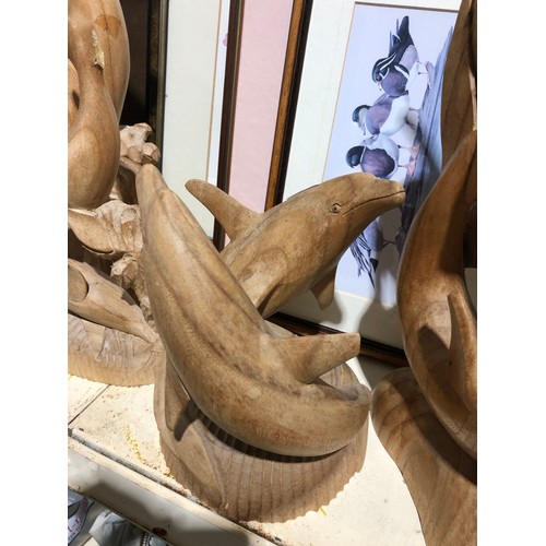 142 - 4 wooden Dolphin sculptures.