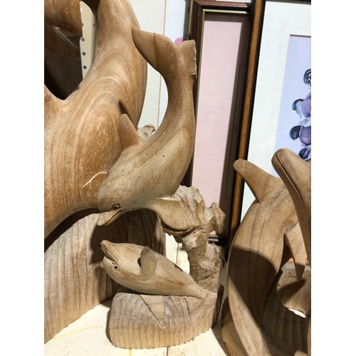 142 - 4 wooden Dolphin sculptures.