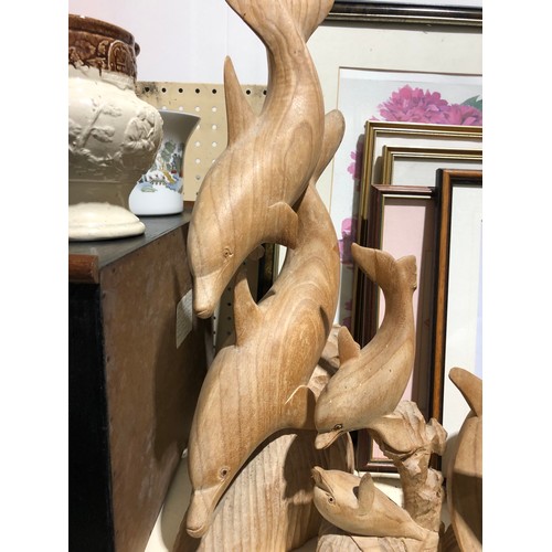 142 - 4 wooden Dolphin sculptures.