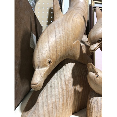 142 - 4 wooden Dolphin sculptures.