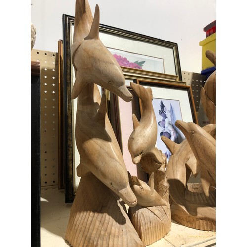 142 - 4 wooden Dolphin sculptures.