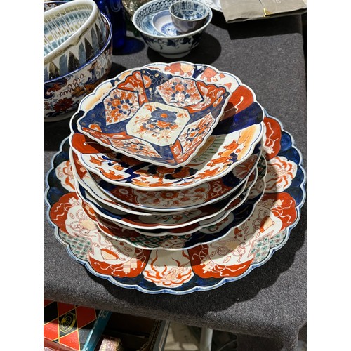 203 - A collection of 8 oriental scalloped imari plates.