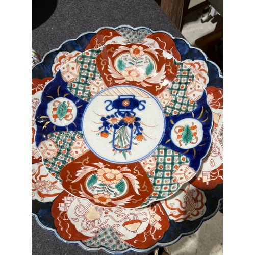 203 - A collection of 8 oriental scalloped imari plates.