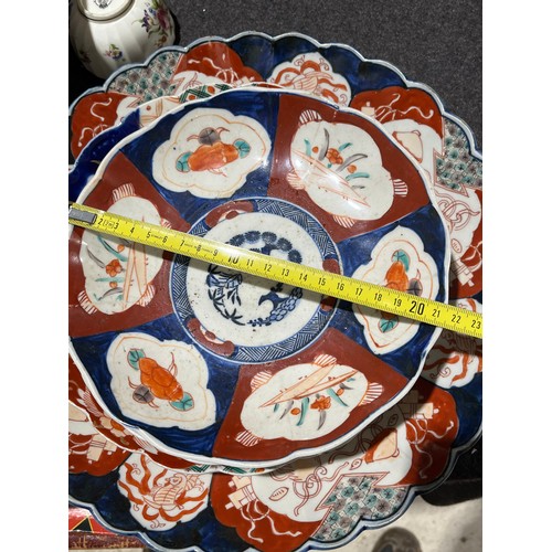 203 - A collection of 8 oriental scalloped imari plates.