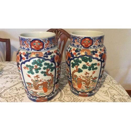 10 - The pair of Oriental in Imari pottery decorative vases, signed under