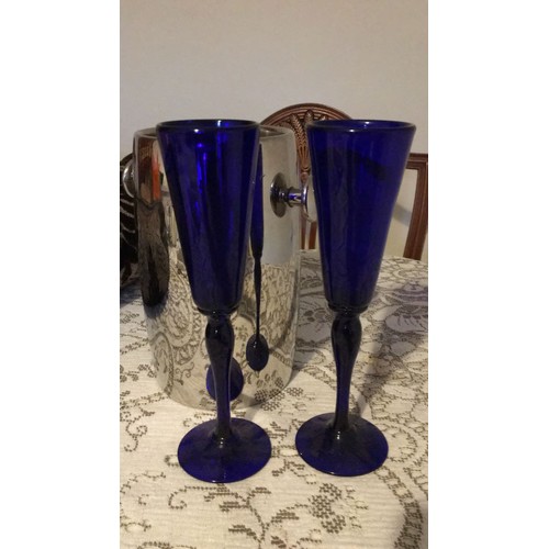 23 - Bristol, blue glass, signed, champagne, flutes And a vintage wine bottle, cooler