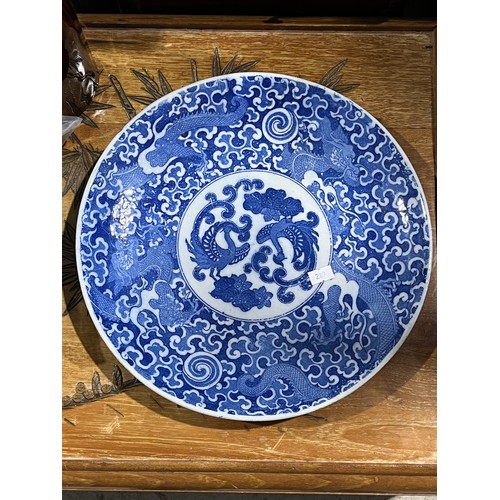 61 - Oriental blue and white platter with bird decoration and blue circular rings under base