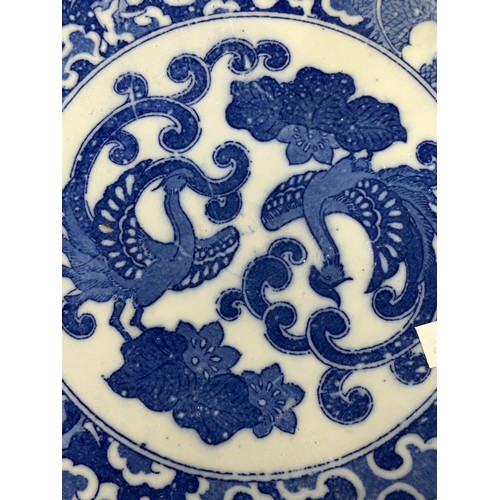 61 - Oriental blue and white platter with bird decoration and blue circular rings under base