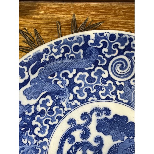 61 - Oriental blue and white platter with bird decoration and blue circular rings under base