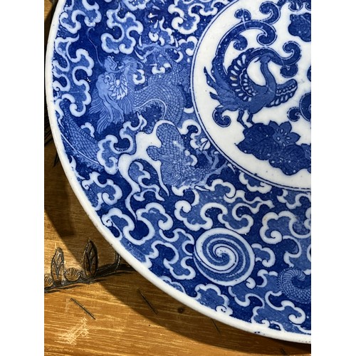 61 - Oriental blue and white platter with bird decoration and blue circular rings under base