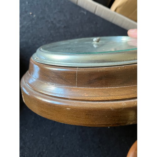 373 - Old Wood cased wall hanging Barometer with stamp to reverse Made in England to front. Diameter 9