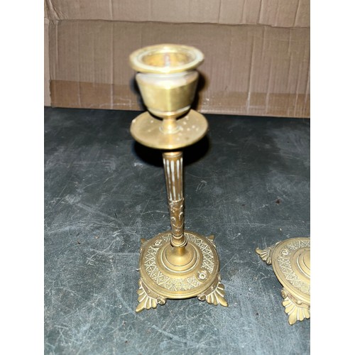 542 - Two brass candlesticks and a pair of coal tongues